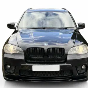 MW X5 E70 front splitter, high-gloss black finish, mounted on the bumper of a black SUV