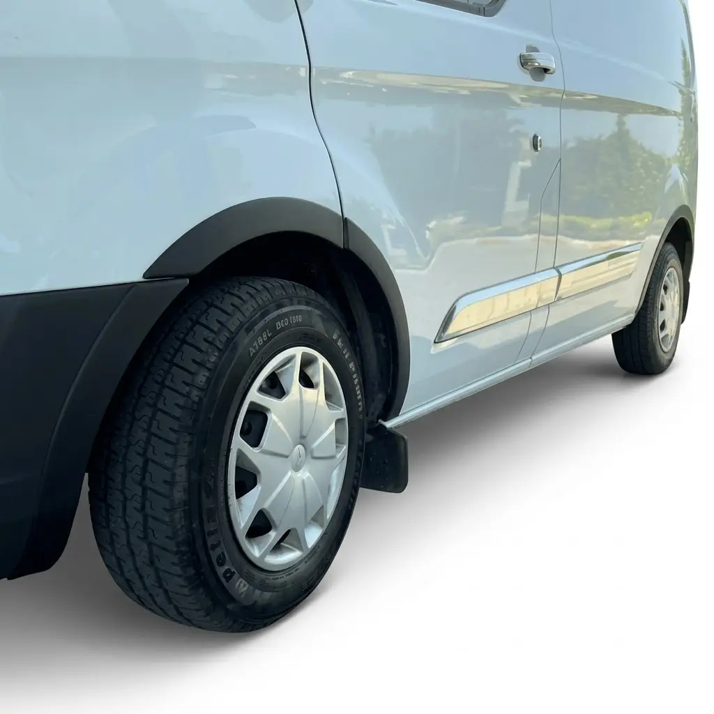 Ford Transit Custom 2012-2018 Wheel Arch Trim Kit 2 Ford Transit Custom 2012-2018 matte black ABS wheel arch extension kit installed on a white van.